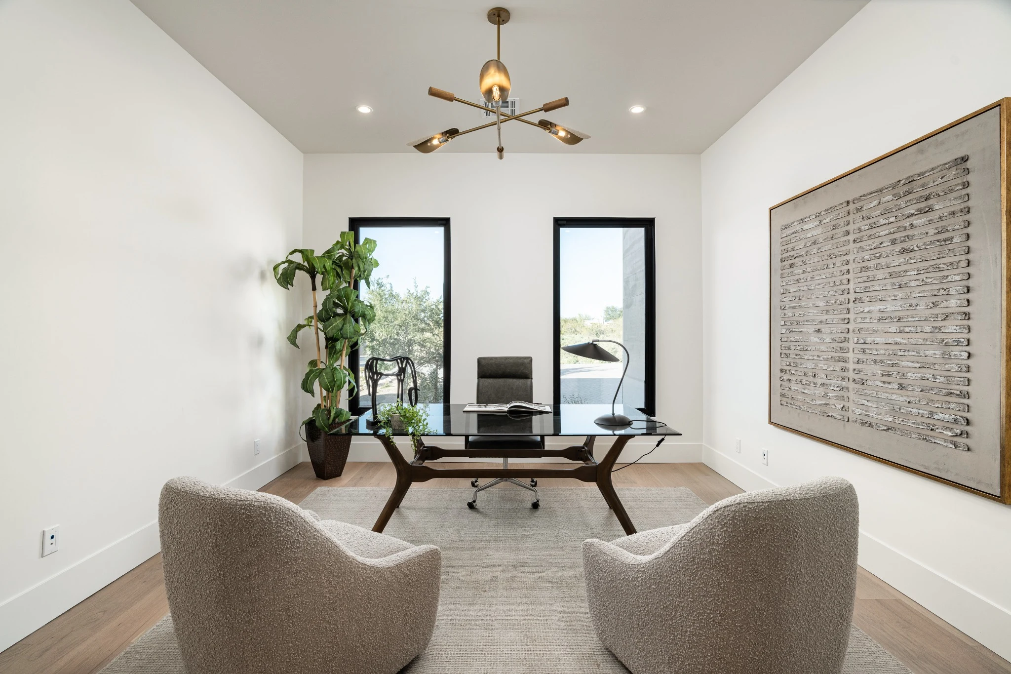 An intimate sitting area with sculptural chairs, natural wood, and soft daylight